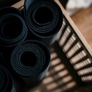 Rolled up yoga mat on a floor